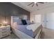 Bedroom featuring an accent wall, ceiling fan, and a light gray carpet at 15313 Lebeau Loop, Winter Garden, FL 34787