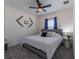 Cozy bedroom featuring soft gray bedding, a ceiling fan, and complementing wall decor at 15313 Lebeau Loop, Winter Garden, FL 34787
