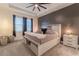 Relaxing bedroom featuring a modern ceiling fan, stylish accent wall, and lots of natural light at 15313 Lebeau Loop, Winter Garden, FL 34787