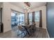 Bright dining room with wood table, modern chairs, and glass sliding doors to outdoor area at 15313 Lebeau Loop, Winter Garden, FL 34787