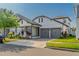 Beautiful two-story home featuring a manicured lawn, two-car garage, and inviting architecture at 15313 Lebeau Loop, Winter Garden, FL 34787