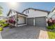 Attractive two-story home with a manicured lawn, gray two-car garage doors, and covered porch at 15313 Lebeau Loop, Winter Garden, FL 34787
