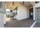 Welcoming front porch with brick pavers, cozy seating, and an inviting entrance at 15313 Lebeau Loop, Winter Garden, FL 34787