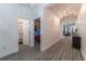 Bright hallway with hard wood flooring, leading to the living area and bedrooms at 15313 Lebeau Loop, Winter Garden, FL 34787