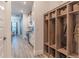 Hallway and mud room connecting the kitchen with a hall tree locker and storage at 15313 Lebeau Loop, Winter Garden, FL 34787