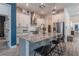 Modern kitchen with large island, granite countertops, stainless steel appliances, and white cabinetry at 15313 Lebeau Loop, Winter Garden, FL 34787