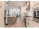 Open concept kitchen with granite countertops, stainless appliances, and view of the dining room at 15313 Lebeau Loop, Winter Garden, FL 34787