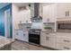 Beautiful kitchen with stainless steel appliances, granite countertops, and white cabinets at 15313 Lebeau Loop, Winter Garden, FL 34787