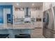 Modern kitchen with stainless steel appliances, granite countertops and white cabinets at 15313 Lebeau Loop, Winter Garden, FL 34787