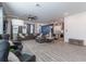 Open-concept living area with hardwood floors, a large sectional sofa, and a modern kitchen at 15313 Lebeau Loop, Winter Garden, FL 34787
