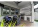 Outdoor kitchen with built-in grill, mini refrigerator, and seating area at 15313 Lebeau Loop, Winter Garden, FL 34787