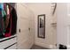 A closet with white storage cabinets, shelves and a mirror at 15313 Lebeau Loop, Winter Garden, FL 34787