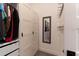 A closet with white storage cabinets, shelves and a mirror at 15313 Lebeau Loop, Winter Garden, FL 34787