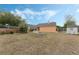 Backyard with a fire pit, shed and partial fence providing privacy and a defined space at 2051 Pernod Ct, Apopka, FL 32703