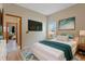 Bright bedroom boasting a comfortable bed, contemporary decor, a mounted TV, and seamless access to other rooms at 2051 Pernod Ct, Apopka, FL 32703