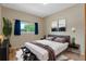 Well-lit bedroom with neutral walls, a comfortable bed, stylish decor, and a large window overlooking the greenery at 2051 Pernod Ct, Apopka, FL 32703
