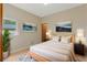 Serene bedroom featuring natural wood accents, a cozy rug, tasteful artwork, and ample natural light from the window at 2051 Pernod Ct, Apopka, FL 32703