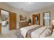 Inviting bedroom with warm tones, a comfortable bed, ample closet space, and an en-suite bathroom for added convenience at 2051 Pernod Ct, Apopka, FL 32703