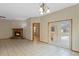 Open-concept living room featuring a brick fireplace, tile flooring, and access to the backyard at 2051 Pernod Ct, Apopka, FL 32703