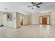 Bright living room with tile flooring, ceiling fan, and an open layout into the kitchen area at 2051 Pernod Ct, Apopka, FL 32703