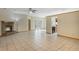 Expansive living room featuring tile floors, a brick fireplace, and access to the kitchen and backyard at 2051 Pernod Ct, Apopka, FL 32703