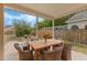 Charming covered patio with wooden dining table and six cushioned chairs, perfect for outdoor entertaining and relaxation at 2051 Pernod Ct, Apopka, FL 32703