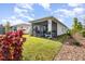 Green backyard with a screened patio, beautiful landscaping, and ample space for outdoor activities at 2587 Cliff Way, St Cloud, FL 34771