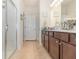 Well-lit bathroom featuring a glass-enclosed shower and a vanity with ample storage at 2587 Cliff Way, St Cloud, FL 34771
