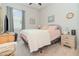 Inviting bedroom with neutral decor, a comfortable bed, and ample natural light from a nearby window at 2587 Cliff Way, St Cloud, FL 34771