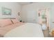 Bright bedroom with a view to the entry of the kitchen, featuring neutral walls and a comfy bed at 2587 Cliff Way, St Cloud, FL 34771