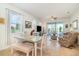 Inviting dining area with a view of the backyard through sliding doors and adjacent open-concept living room at 2587 Cliff Way, St Cloud, FL 34771