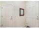 Clean entryway with white doors and neutral wall color with mirror and light switch at 2587 Cliff Way, St Cloud, FL 34771