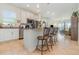 Open-concept kitchen with granite counters, stainless appliances, and bar seating overlooking living area at 2587 Cliff Way, St Cloud, FL 34771