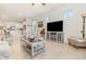 Bright living room featuring open layout to the kitchen and modern tile flooring throughout at 2587 Cliff Way, St Cloud, FL 34771