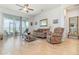Cozy living room featuring tile flooring, ceiling fan, sliding doors, and comfortable seating arrangement at 2587 Cliff Way, St Cloud, FL 34771