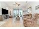 Bright living room with sliding glass doors leading to a screened lanai and views of the backyard at 2587 Cliff Way, St Cloud, FL 34771