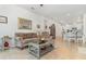 Comfortable living room with tile floors, ceiling fan and view of dining area and kitchen at 2587 Cliff Way, St Cloud, FL 34771
