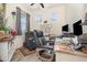 Comfortable home office with a recliner, desk, and natural light from the windows at 2587 Cliff Way, St Cloud, FL 34771