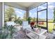 Comfortable screened patio with cushioned chairs and table, surrounded by lush greenery and views at 2587 Cliff Way, St Cloud, FL 34771
