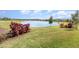 Picturesque view of a serene pond surrounded by lush greenery and neatly kept landscaping at 2587 Cliff Way, St Cloud, FL 34771