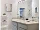 Bathroom with gray vanity, granite countertop and white shelving unit to the side at 2781 Almaton Loop # 203, Kissimmee, FL 34747
