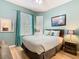 Bedroom featuring teal walls, laminate floor, and corner windows at 2781 Almaton Loop # 203, Kissimmee, FL 34747