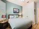 Cozy bedroom featuring cool toned teal walls, laminate floors, and a ceiling fan at 2781 Almaton Loop # 203, Kissimmee, FL 34747