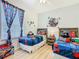 Spiderman-themed bedroom featuring two twin beds and laminate floors at 2781 Almaton Loop # 203, Kissimmee, FL 34747