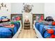 bedroom showcasing superhero decor, two twin beds and laminate floors at 2781 Almaton Loop # 203, Kissimmee, FL 34747