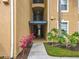 Inviting building entrance with colorful landscaping and clear address signage for easy identification at 2781 Almaton Loop # 203, Kissimmee, FL 34747