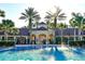 Exterior view of the clubhouse and pool featuring lush landscaping at 2781 Almaton Loop # 203, Kissimmee, FL 34747