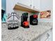 Coffee station on granite countertops, complete with Keurig and other coffee makers, perfect for coffee lovers at 2781 Almaton Loop # 203, Kissimmee, FL 34747
