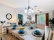 Stylishly decorated dining room featuring a rustic wood table and seating for six guests at 2781 Almaton Loop # 203, Kissimmee, FL 34747