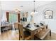 Bright dining room features a wood table, seating for six, and a view into the living room and balcony at 2781 Almaton Loop # 203, Kissimmee, FL 34747